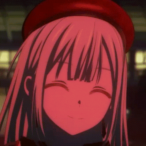 a close up of a girl 's face with red lights behind her