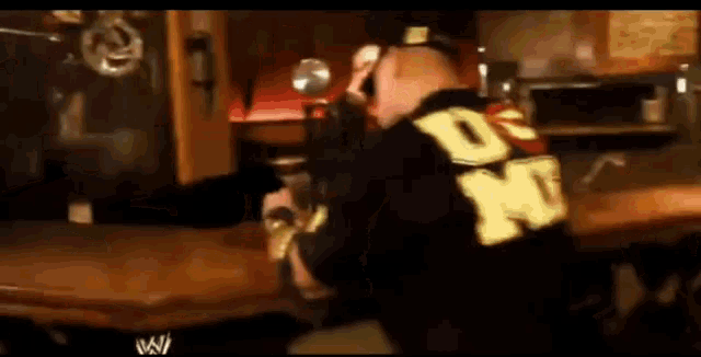 a man wearing a black shirt with the letter dn on it
