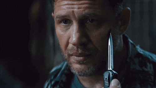 a man holding a knife with the words say when written on the bottom