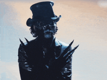 a man wearing a skull mask and a cowboy hat looks at the camera