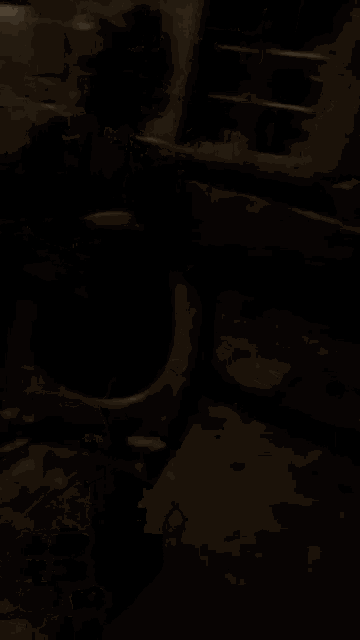 a person is standing in the dark holding a metal container