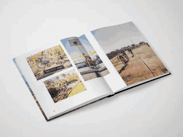 a book is open to a page with a picture of a person riding a bike and a sign that says santiago