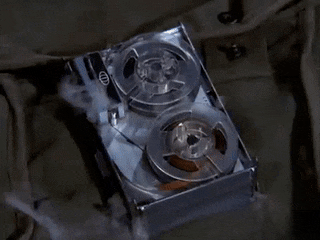 a close up of a tape recorder with two reels of tape on it .