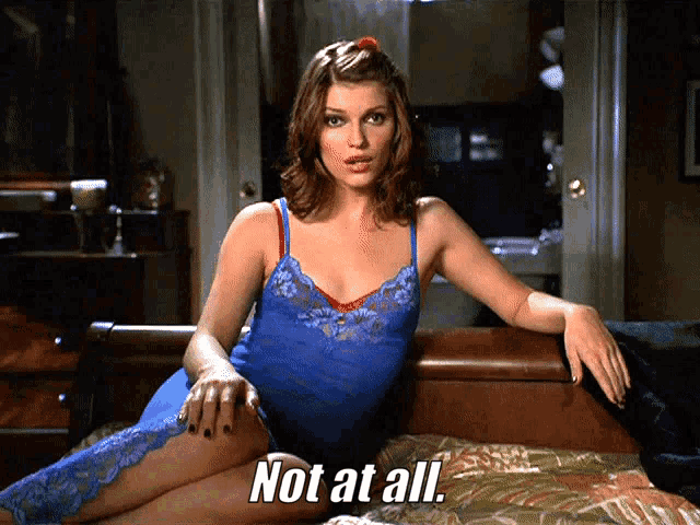 a woman in lingerie is laying on a bed with the words not at all above her