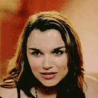 a close up of a woman 's face with a blurry background .