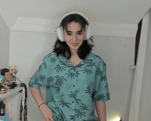 a woman wearing headphones and a blue shirt with palm trees