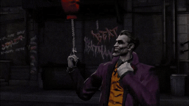 the joker is holding a red balloon in his hand