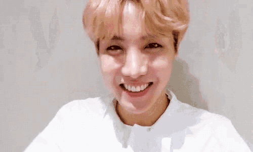 a close up of a person 's face with a smile on his face .