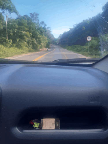 a box of cigarettes sits on the dashboard of a car with a speed limit of 40