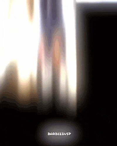 a blurred image of a person standing in front of a window with barbiezusp written on the bottom