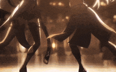 a couple of anime characters are dancing on a dance floor .