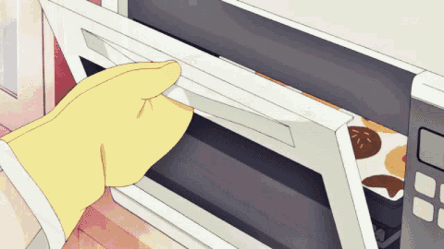 a person wearing a yellow glove is opening a microwave door