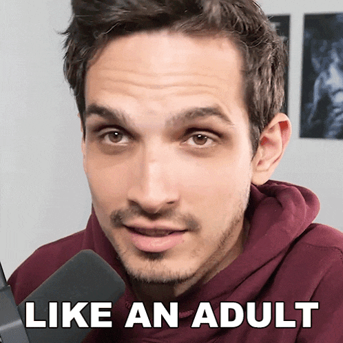 a man with a beard is wearing a maroon hoodie and has the words like an adult on his face