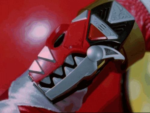 a close up of a red toy that looks like a dinosaur head