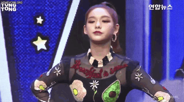 a woman wearing a shirt that says breakfast is served on it