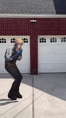 a video of a man dancing in front of a brick garage door