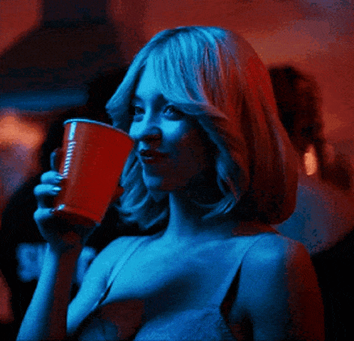 a woman is drinking from a red cup that says jimmy john 's on it