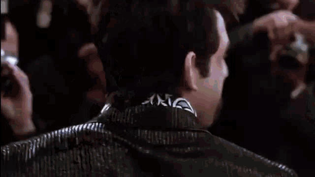 a man with a bandana on his neck is looking at something