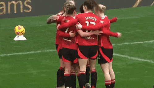 a group of female soccer players huddle together with one wearing the number 17 on her back