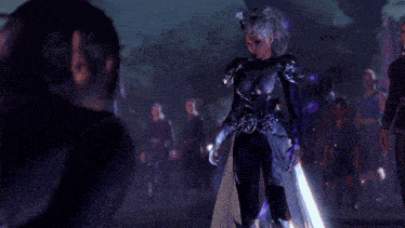 a group of people are standing in a dark room with a woman in a purple outfit standing in the middle