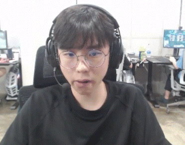 a young man wearing glasses and headphones is sitting in a chair