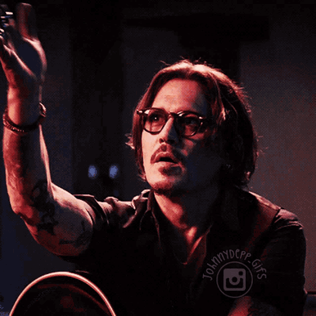 a man wearing glasses is being photographed by johnnydepp