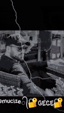 a black and white photo of a man sitting in a chair with the words " emucize " below him