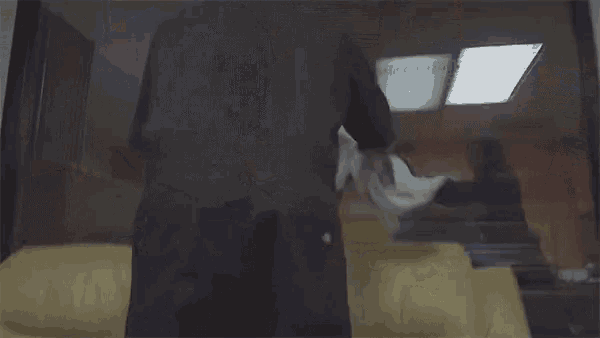 a person laying on a couch with blood on their clothes