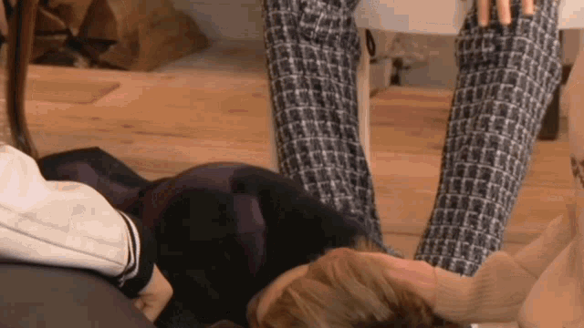 a woman is laying on the floor with her legs up