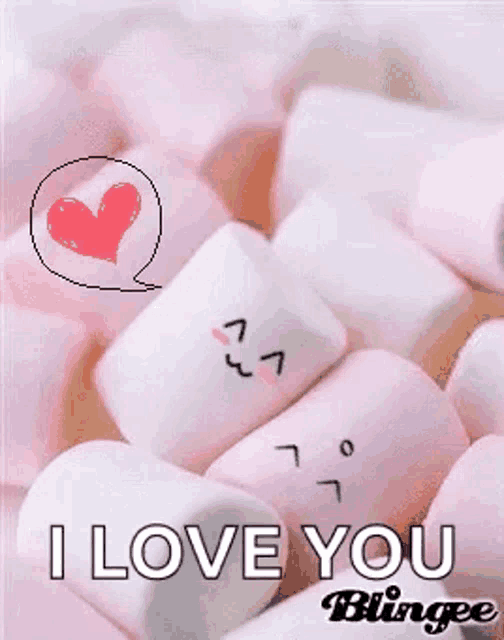 a pile of pink marshmallows with faces drawn on them and a heart in the background .