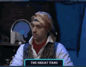 a man sitting in front of a sign that says ' the great vano '