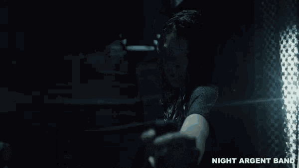 a man is taking a picture of himself in a dark room with a flashlight .