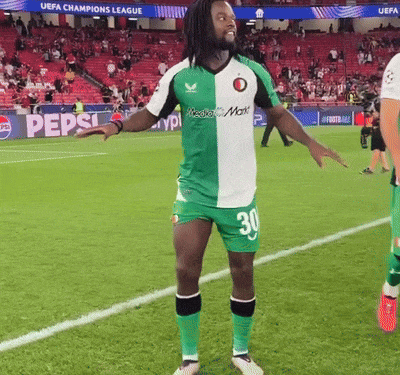 a man in a green and white jersey with the number 30 on it