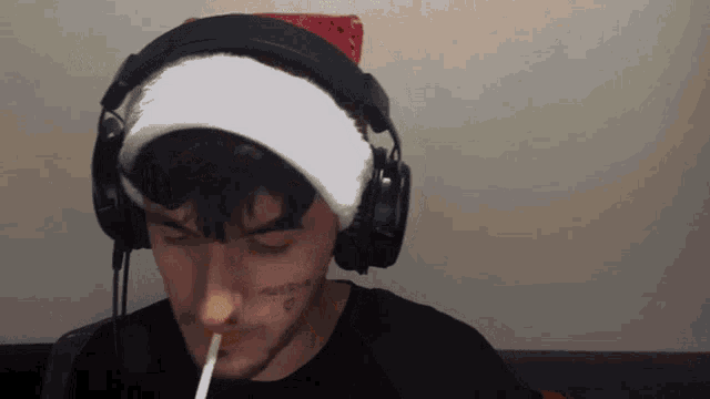 a person wearing headphones and a santa hat