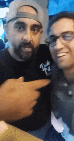 two men are posing for a picture and one of them is wearing a shirt that says ' daddy ' on it