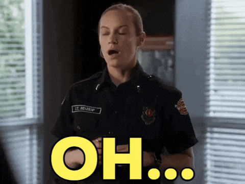 a woman in a firefighter uniform says " oh " with her mouth open