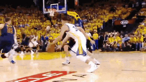 a basketball game being played in front of a kia ad