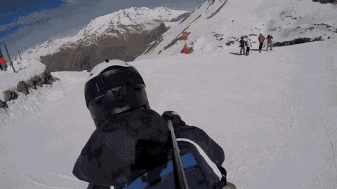 a person is skiing down a snow covered slope