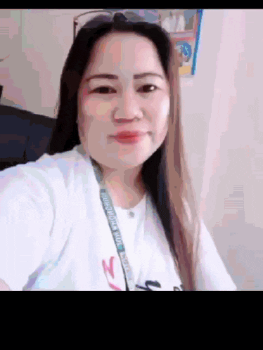 a woman is taking a selfie with a lanyard around her neck that says california state