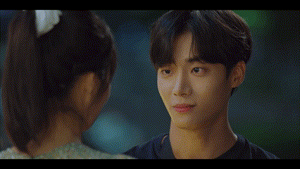 a man and a woman are looking into each others eyes .