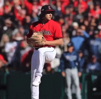 a baseball player wearing a red jersey that says indians on it