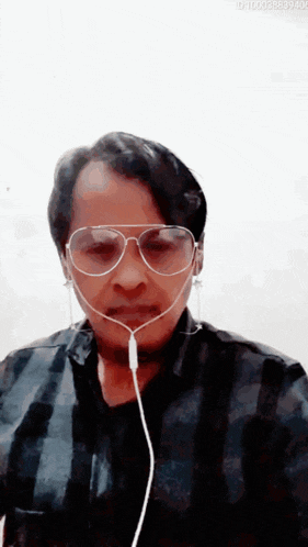 a man wearing a pair of sunglasses and earphones