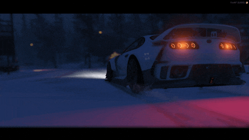 a car is driving down a snowy road at night with the letters m on the side