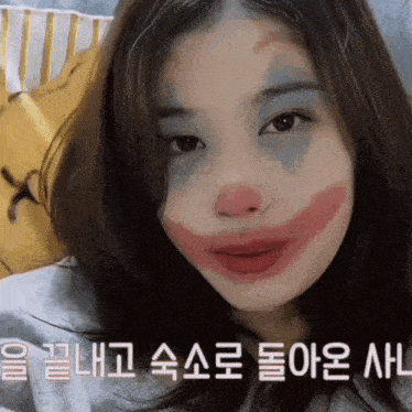 a woman with a clown face painted on her face with korean writing behind her