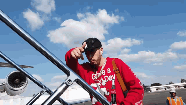 a man wearing a red sweater that says give a holiday