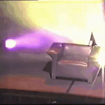 a purple light is shining on a chair on a stage