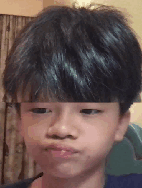 a close up of a young boy 's face with a blurred background