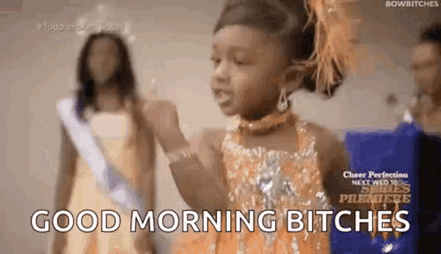 a little girl in a pageant dress is giving a thumbs up and says `` good morning bitches '' .