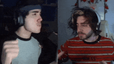 a man wearing headphones and a headband is talking to another man wearing a guess sweater .