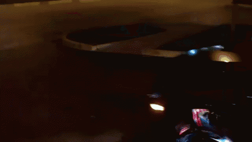 a car is driving down a street at night in front of a mcdonald 's